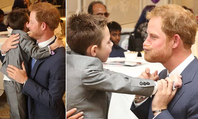 Heartwarming: Prince Harry received a warm embrace from a young boy whose debilitating medical condition means he is barely able to walk... See more ππ